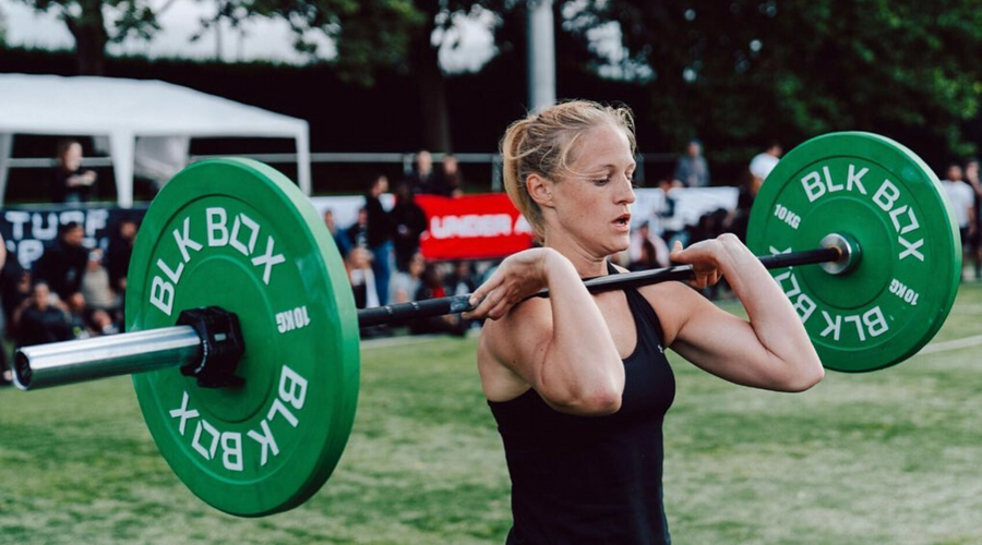 Woman using BLK BOX Barbell