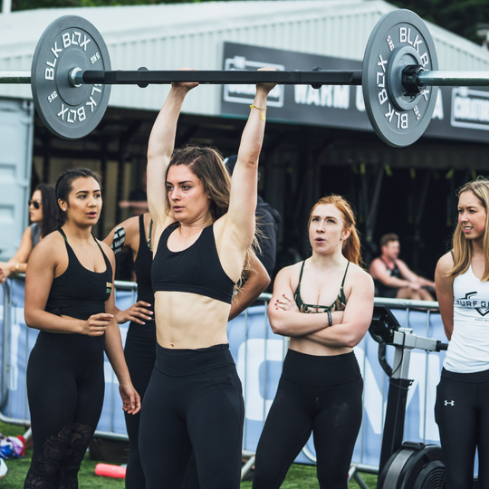 woman using BLK BOX weight plates