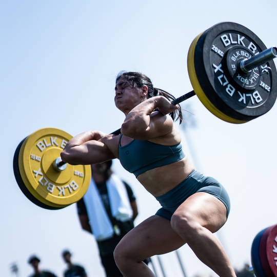 woman using BLK BOX weight plates