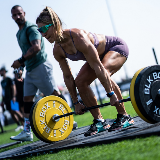 woman using BLK BOX weight plates